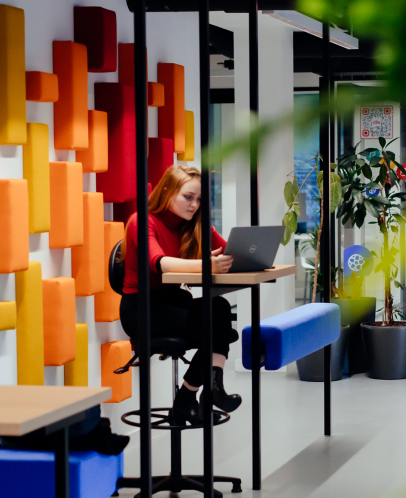 Woman working at desk in colorful office