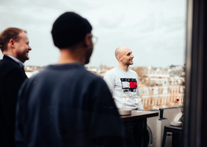 A group of male coworkers chatting on office rooftop